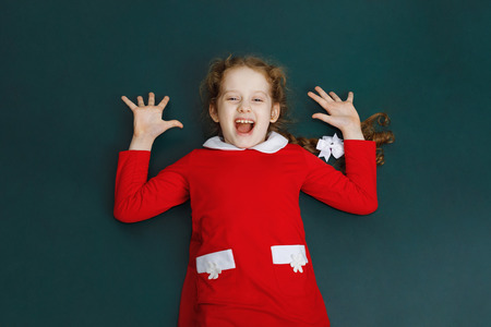 Happy laughing girl in red dress. の写真素材