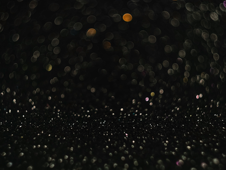 Black bokeh background, abstract with defocused lights.の写真素材