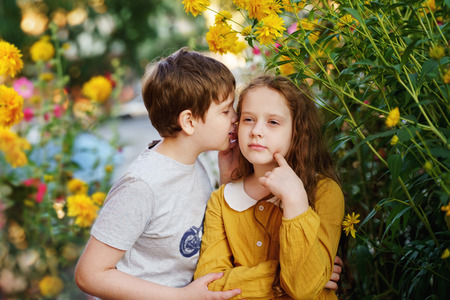 Cute children whispers in summer outdoors. Happe childhood concept.の写真素材