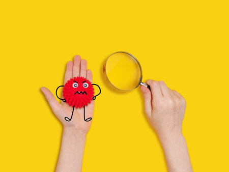 Child see the   bacteria on his hand through a magnifying glass. Healthy, medical concept.の写真素材