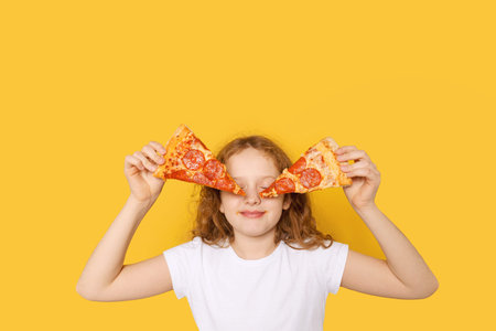 Hungry girl dressed in white t-shirt, holds two slices of pizza and closed eyes from pleasure, photo...