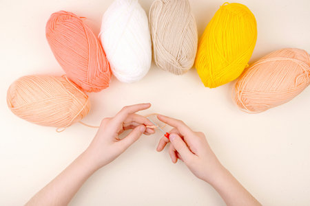 Human hand holding with yarn and crochet hook. Flat Lay background.の写真素材
