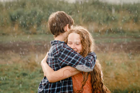 Children smile hugging outdoors. friendship concept.の写真素材