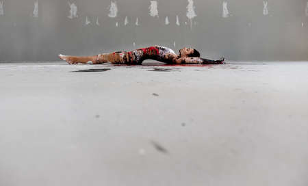 artistically abstract painted young sexy woman in underwear, sportswear, lies on the floor in the artists studio, copy space.の写真素材