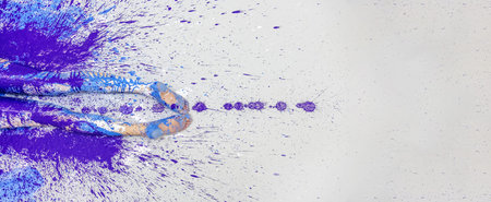 legs and feet of a sexy young painted woman with blue, violet, pink, purple and white paint on the...