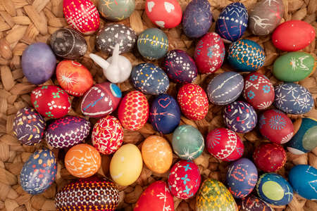 many hand painted colorful easter eggs in a woven basket according to Sorbian tradition, copy spaceの写真素材