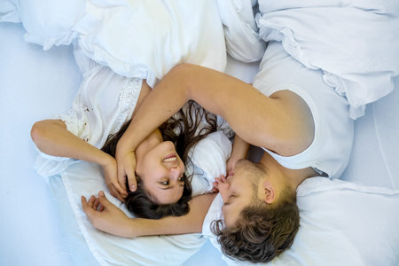 Upside down top view of a romantic, attractive, contented, young, hugging sexy loving couple in...