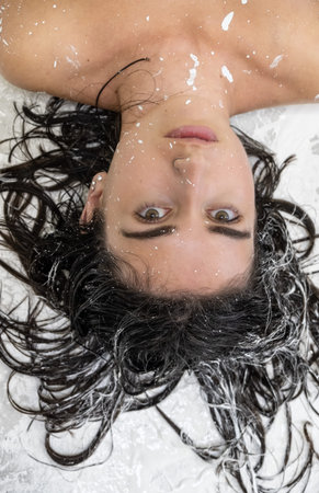 Portrait of a sexy young woman with dots of white color painted decorative. Creative expressive...