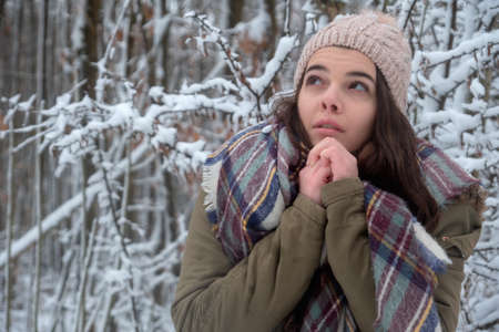 Winter girl portrait with scarf, hat. Beauty joyful model cold in winter park. Beautiful young female nature, enjoying nature,の写真素材