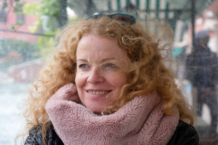 Portrait of a beautiful mature woman with red curly hair on vacation in Venice, Italy