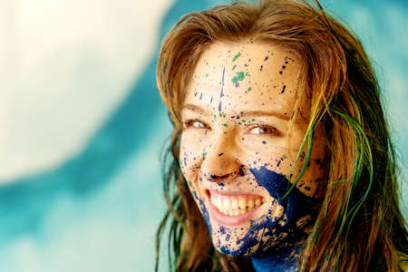 Portrait of a sexy young brunette redhead woman, dots of blue and green color, decorative, creative expressive abstract body painting art, make up, copy space.の写真素材