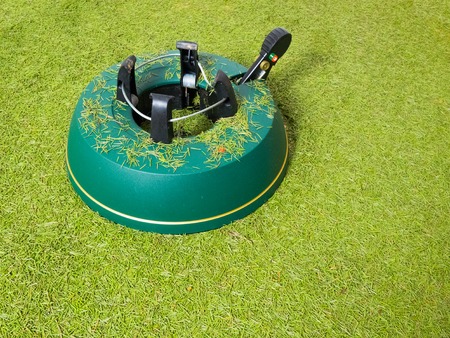 Empty Christmas tree stand with floor covered by fir needlesの写真素材