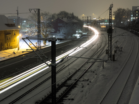 Light trail of a train at night in winterの写真素材