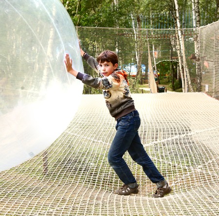 boy play huge ball in outdoor sport open air activity parkの写真素材