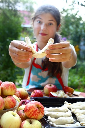 girl cook apple croissants with own apples from garden treesの写真素材