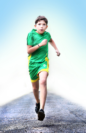 teenager  boteenager boy in sportswear run on the country roady in sportswear run on the country roadの写真素材