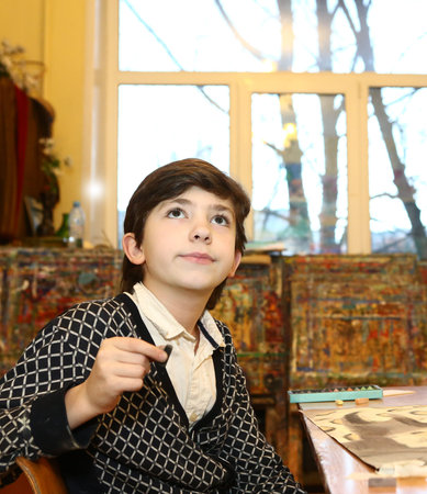 MOSCOW, DECEMBER  24, 2015: Unidentified art school student boy participate in final  painting...