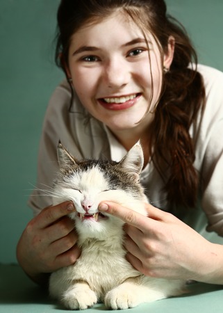 teenage pretty gilr with dark long hair hold siberian male cat smilingの写真素材