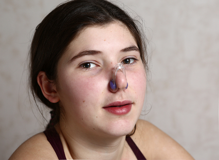 synchronized swimming teenage team member girl close up portrait in nose clipの写真素材