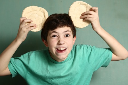 preteen handsome boy perform beast image with tortilla ears sharp teeth close up portriatの写真素材