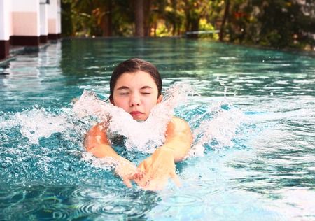 pretty swimmer teenager girl exercise in swimming poolの写真素材
