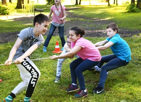 Moscow, Russia - May 31, 2016: Unidentified preteen kids play rope pull outdoor competition game in graduation school party in Moscow, May 31, 2016のeditorial素材