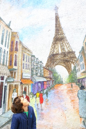 Moscow,Russia - September 19, 2016: Unidentified boy look at paris graffiti on the wall in famous park fair.のeditorial素材