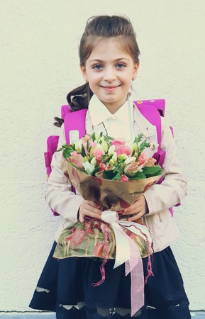 Moscow, Russia - September 1, 2016: Unidentified girls with flowers bouquet on solemn meeting of first grade kids, called the Day of Knowledge, signify the beginning of school year.のeditorial素材