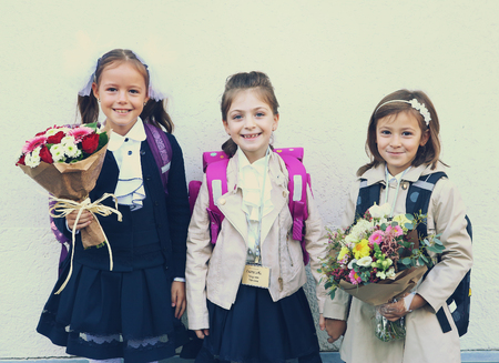 Moscow, Russia - September 1, 2016: Unidentified girls with flowers bouquet on solemn meeting of first grade kids, called the Day of Knowledge, signify the beginning of school year.のeditorial素材