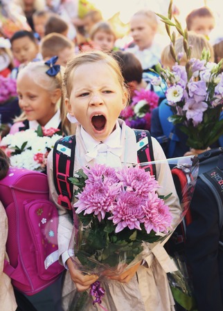 Moscow, Russia - September 1, 2016: Unidentified girls with flowers bouquet on solemn meeting of first grade kids, called the Day of Knowledge, signify the beginning of school year.のeditorial素材