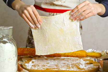 Preparation of the dough. Preparation of the dough the women's hands. On a wooden table. Front view