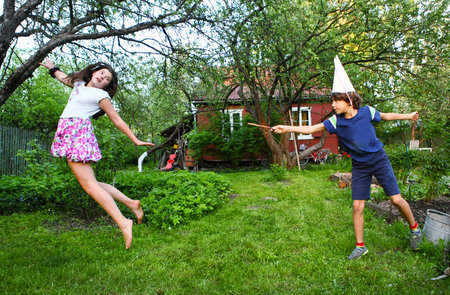 siblings boy and girl play game with magic stick