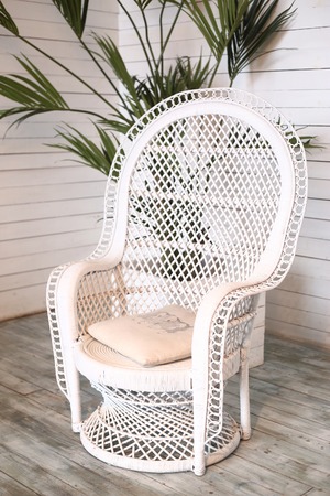 wicker white armchair in shabby chic close up photoの写真素材
