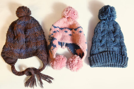 knitted winter hats lay in row close up photo