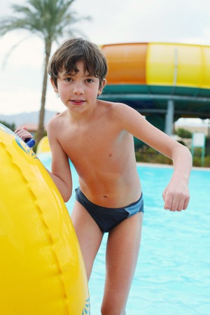 preteen little boy in aqua park close up photoの写真素材