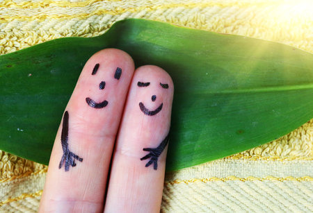 finger couple lay on the towel sunbathing smile happy