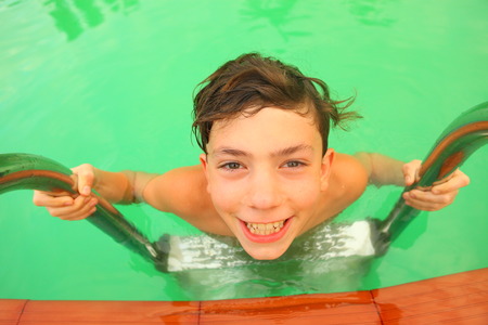 boy in swimming pool close up portraitの写真素材