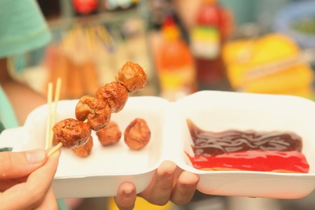 asian fast street food roasted tofu on stick with saucesの写真素材