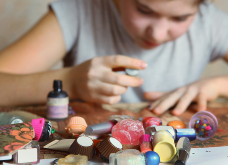 beautiful preteen girl make manicure with black nail enamelの写真素材