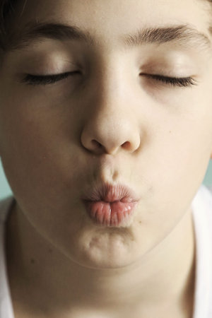 teenage boy with kiss grimace close eyes close up portrait