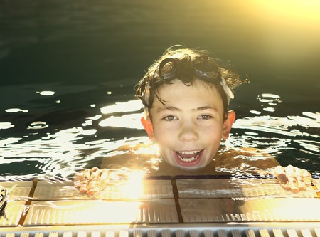 teenager boys in open air swimming pool smiling portraitの写真素材