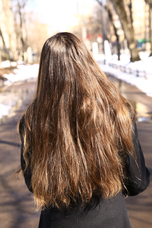 teenager girl with long brown hair back viewの写真素材