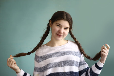 teen girl with plaited long brown hair braids