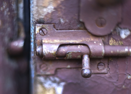 old vintage latch lock on blue shabby cracked painted door close up photoの写真素材