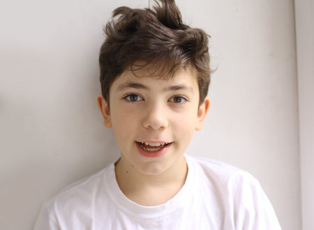 teen smiling happy boy with shaggy hair close up photo