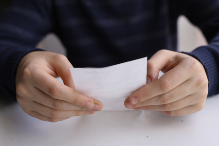 hands hold cheque bill close up photo in cafeの写真素材