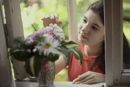 teenager girl with hydrangea boupuet close up photo on summer green backgroundの写真素材