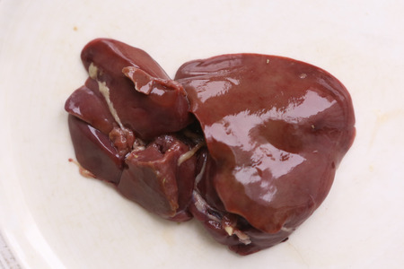 peice of chicken liver close up photo on white backgroundの写真素材