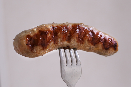 roasted stuffed  blood sausage close up photo on forkの写真素材