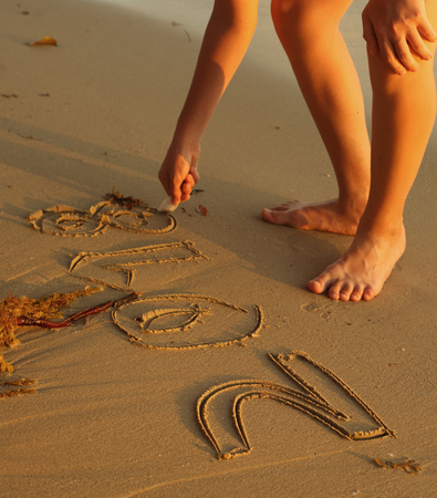 kids hand drawing 2018 script on sand apply to wonderful christmas holiday on tropical thai islandの写真素材